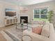 Cozy living room with fireplace, large window, stylish furnishings, and a view of the landscaped yard at 1973 Parish House Cir, Johns Island, SC 29455