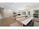 Open-concept living and dining areas, showcasing hardwood floors, a fireplace, and ample natural light at 1973 Parish House Cir, Johns Island, SC 29455