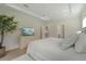 Bright main bedroom with a plush bed, hardwood floors, TV, and a calming atmosphere at 1973 Parish House Cir, Johns Island, SC 29455