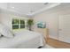 Relaxing main bedroom with hardwood floors, large window, tray ceiling and a decorative tree at 1973 Parish House Cir, Johns Island, SC 29455