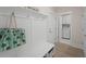 Functional mudroom with storage bench, hooks, and access to a laundry room for added convenience at 1973 Parish House Cir, Johns Island, SC 29455