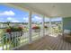 Charming covered patio features inviting outdoor seating, vibrant flowers, and views of the picturesque neighborhood at 1973 Parish House Cir, Johns Island, SC 29455