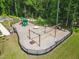 Aerial view of a fenced playground with swings, slides, and a central merry-go-round at 1973 Parish House Cir, Johns Island, SC 29455