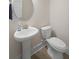 Compact powder room with a pedestal sink, round mirror, and a white toilet at 1973 Parish House Cir, Johns Island, SC 29455