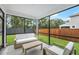 Comfortable screened porch with plush seating and serene views of the private fenced backyard at 1973 Parish House Cir, Johns Island, SC 29455