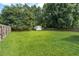 Spacious, verdant backyard with a privacy fence and storage shed, providing ample space for outdoor activities at 1975 Fruitwood Ave, Charleston, SC 29414