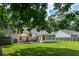 Expansive backyard featuring a well-maintained lawn, covered patio, and mature trees, perfect for outdoor gatherings at 1975 Fruitwood Ave, Charleston, SC 29414