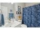 Bright bathroom showcasing blue accents, framed art, and a charming shower curtain at 1975 Fruitwood Ave, Charleston, SC 29414
