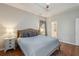 Comfortable bedroom features a tray ceiling, wood floors, and ensuite bath access at 1975 Fruitwood Ave, Charleston, SC 29414