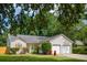 Charming single-Gathering home with a well-manicured lawn, a two-car garage, and mature trees at 1975 Fruitwood Ave, Charleston, SC 29414