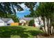 Charming home with a well-manicured lawn, complemented by lush trees and a welcoming front exterior at 1975 Fruitwood Ave, Charleston, SC 29414