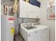 Well-equipped laundry room with a washer, dryer, and ample storage cabinets at 1975 Fruitwood Ave, Charleston, SC 29414