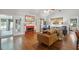 Cozy living room with hardwood floors, fireplace with red tile and French doors to another room at 1975 Fruitwood Ave, Charleston, SC 29414