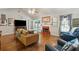 Open living room with hardwood floors, fireplace, neutral paint, and a ceiling fan at 1975 Fruitwood Ave, Charleston, SC 29414