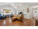 Open living space with hardwood floors, fan, and a view of the kitchen and dining area at 1975 Fruitwood Ave, Charleston, SC 29414