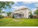 A large backyard featuring a screened in porch and a wood fence at 201 Old Market Ct, Moncks Corner, SC 29461