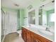 Bathroom featuring a double vanity with cherry wood cabinets and modern light fixtures at 201 Old Market Ct, Moncks Corner, SC 29461