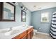 This bathroom features a double sink vanity, framed mirrors and blue walls at 201 Old Market Ct, Moncks Corner, SC 29461