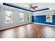 Spacious bedroom with tray ceiling, hardwood floors, and ample natural light at 201 Old Market Ct, Moncks Corner, SC 29461