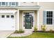Close up of entrance featuring a beautiful front door and two-car garage on left at 201 Old Market Ct, Moncks Corner, SC 29461