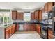 A kitchen with dark wood cabinets, a tile backsplash, and stainless steel appliances at 201 Old Market Ct, Moncks Corner, SC 29461