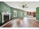 Open-concept living room with hardwood floors, a fireplace, and plenty of natural light at 201 Old Market Ct, Moncks Corner, SC 29461