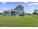 Back view of the house with a screened porch and a spacious backyard at 2032 Sea Water Dr, Charleston, SC 29412
