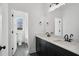 Modern bathroom featuring dual sinks, sleek black fixtures, and black and white tiled flooring at 2032 Sea Water Dr, Charleston, SC 29412