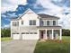 Beautiful two-story home with a well-manicured lawn and a welcoming front porch at 2032 Sea Water Dr, Charleston, SC 29412