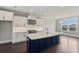 Bright kitchen featuring an island with quartz countertops, stainless steel appliances, and white cabinets at 2032 Sea Water Dr, Charleston, SC 29412