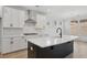 Bright kitchen featuring white cabinets, a large island, and stainless steel appliances at 2032 Sea Water Dr, Charleston, SC 29412