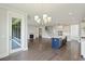 Open concept living room and kitchen area with hardwood floors, fireplace, and modern lighting at 2032 Sea Water Dr, Charleston, SC 29412