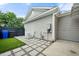 A fenced backyard features stone pavers, artificial grass, and convenient access to home utilities at 2064 Promenade Ct, Mount Pleasant, SC 29466