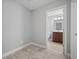 Neutral bedroom leading to a bathroom with neutral carpet flooring and light gray painted walls at 2064 Promenade Ct, Mount Pleasant, SC 29466