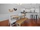 Dining area showcases wood table, seating, stylish decor, and a breakfast bar in the background at 2064 Promenade Ct, Mount Pleasant, SC 29466