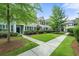 Exterior townhome view highlighting well-maintained landscaping, walkways, and a green lawn at 2064 Promenade Ct, Mount Pleasant, SC 29466