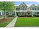 Charming townhome featuring a classic facade, neatly trimmed bushes, and a vibrant green lawn at 2064 Promenade Ct, Mount Pleasant, SC 29466