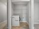 Laundry closet with stacked washer/dryer and wire shelving for convenient storage at 2064 Promenade Ct, Mount Pleasant, SC 29466
