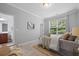 Bedroom features a large window with serene views and an ensuite bathroom at 2064 Promenade Ct, Mount Pleasant, SC 29466