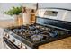 Close-up of a stainless steel gas cooktop with granite countertops at 2064 Promenade Ct, Mount Pleasant, SC 29466