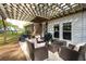 Outdoor patio with pergola, featuring comfortable wicker seating and grilling area, perfect for entertaining at 2158 Till Rd, Charleston, SC 29414