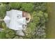 An aerial view showcasing the house's roof, deck, patio, landscaping and surrounding greenery at 228 Beresford Creek St, Charleston, SC 29492