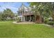 Backyard featuring a multi-level deck and patio area with lush lawn and mature trees at 228 Beresford Creek St, Charleston, SC 29492