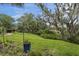 Beautifully landscaped backyard with lush greenery, flowers, and mature trees at 228 Beresford Creek St, Charleston, SC 29492