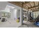 Unfinished basement with concrete walls, exposed beams, utility storage, and backyard access at 228 Beresford Creek St, Charleston, SC 29492