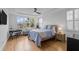 Tranquil bedroom features a tray ceiling, large windows, and a cozy bed at 228 Beresford Creek St, Charleston, SC 29492