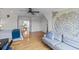 Large bedroom with hardwood floors featuring a queen bed, large sofa, and an open hallway at 228 Beresford Creek St, Charleston, SC 29492