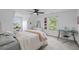 Bright bedroom featuring a ceiling fan, white walls, and a study area with views of the outdoors at 228 Beresford Creek St, Charleston, SC 29492