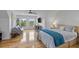 Bright bedroom with hardwood floors featuring a full bed, desk, and comfortable seating area at 228 Beresford Creek St, Charleston, SC 29492