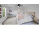 Bright bedroom featuring a ceiling fan, carpet floors, and a light pink comforter draped over the bed at 228 Beresford Creek St, Charleston, SC 29492